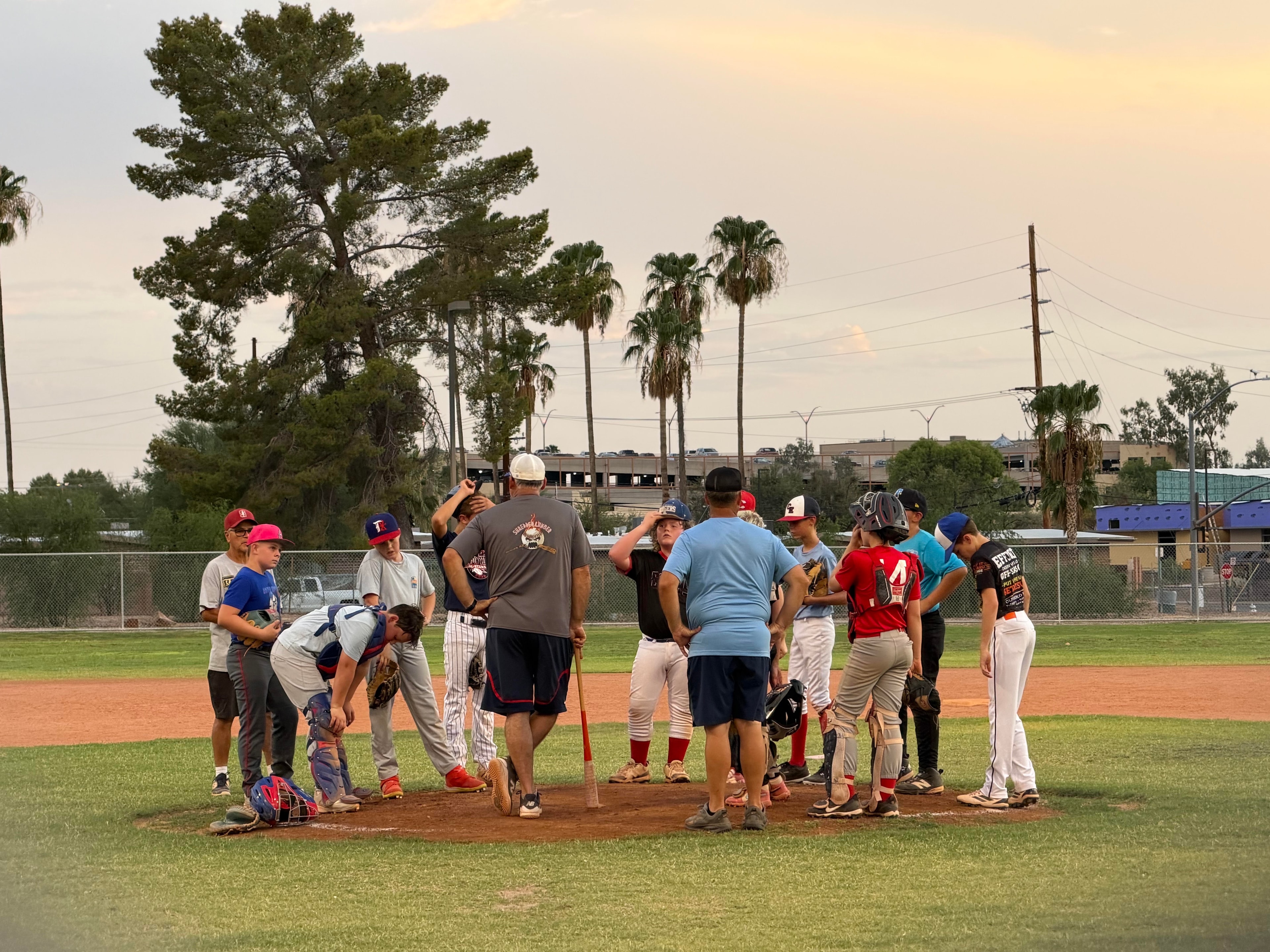 Players gathered at the mound during practice