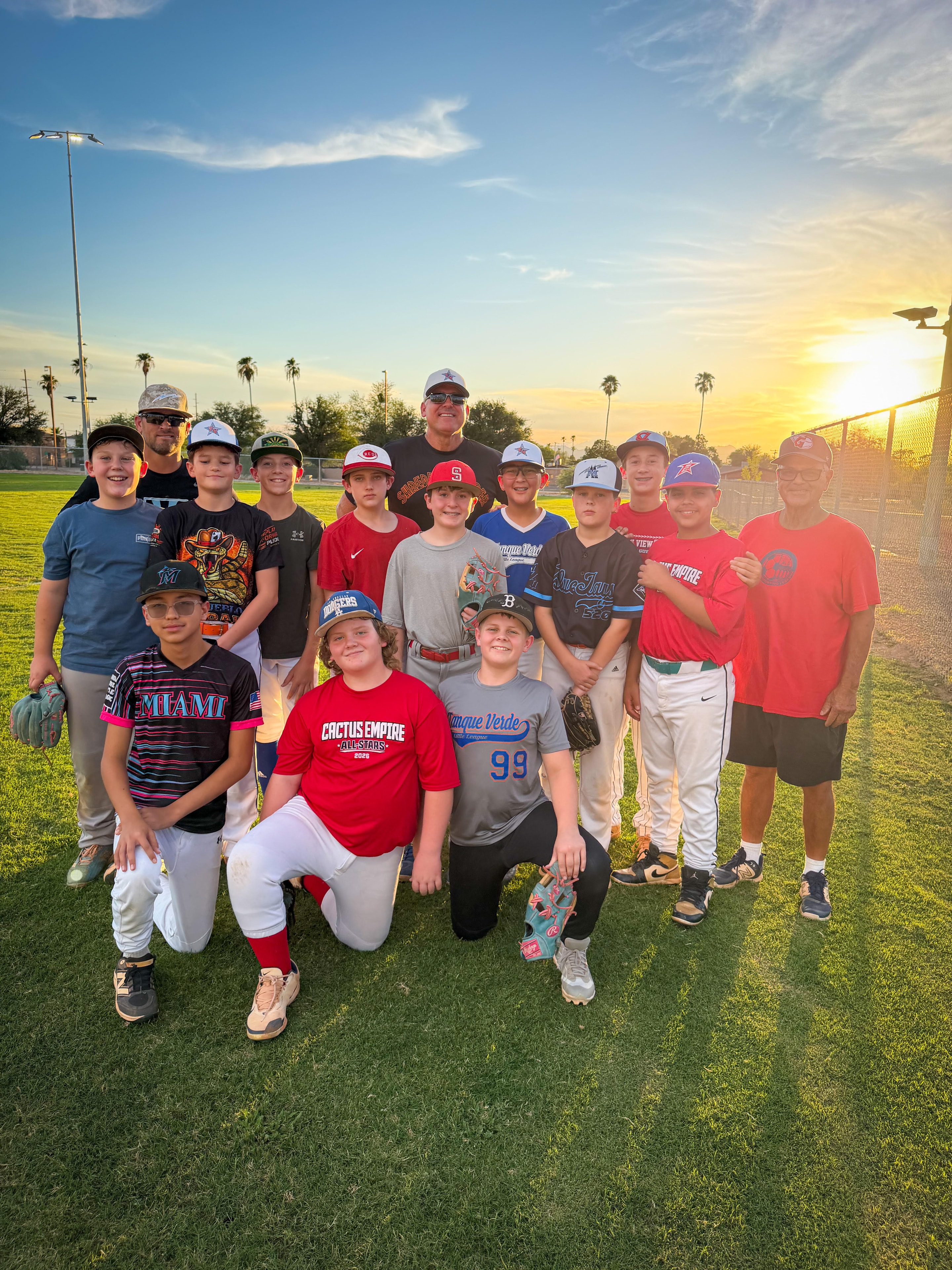 Team and coaches group photo at sunset on the field
