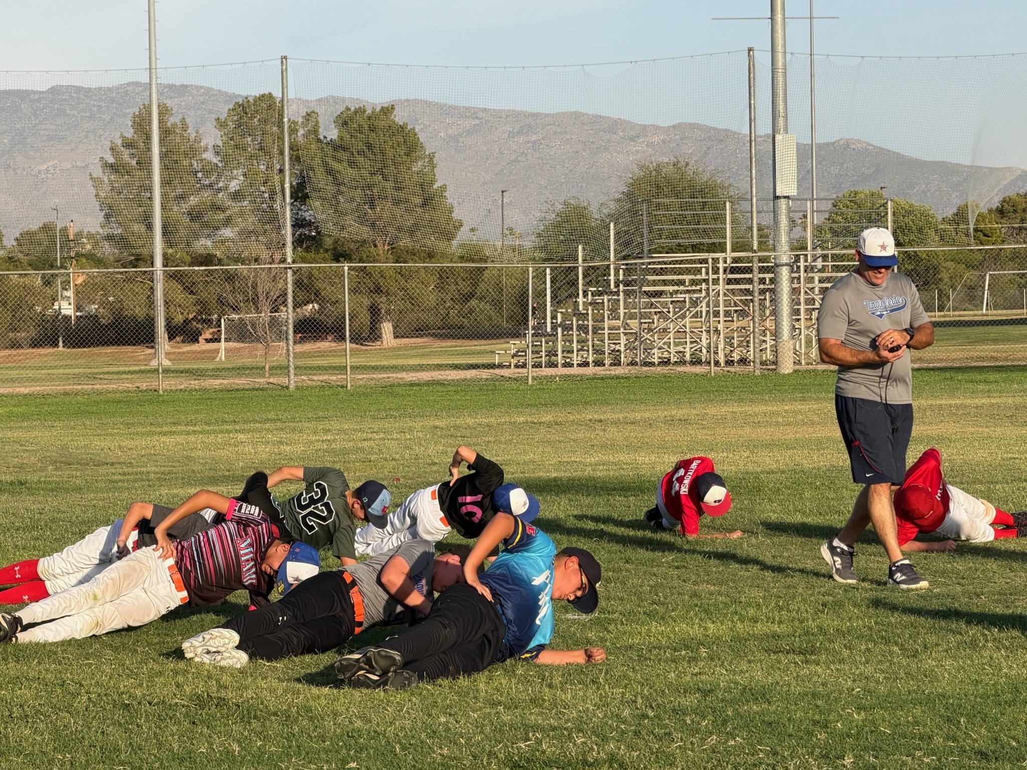 Baseball coach instructing young Titans players